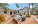 Stunning backyard with multiple seating areas, lush landscaping, and mature palm trees at 1682 Hawthorne St, Sarasota, FL 34239