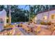 Expansive backyard patio with an outdoor dining table, seating, and a serene water feature at 1682 Hawthorne St, Sarasota, FL 34239