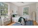 Bright bedroom featuring plush bedding, natural light, and stylish decor at 1682 Hawthorne St, Sarasota, FL 34239
