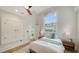 Comfortable bedroom with ample natural light, wood floors, and a built-in closet at 1682 Hawthorne St, Sarasota, FL 34239