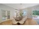 Dining room with hardwood floors, a modern table, and a view of the backyard and pool at 1682 Hawthorne St, Sarasota, FL 34239