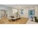 Open-concept dining area with hardwood floors and seamless access to a bright and airy living room at 1682 Hawthorne St, Sarasota, FL 34239