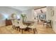 Open dining room with hardwood floors, decorative lighting, and a seamless transition to the kitchen at 1682 Hawthorne St, Sarasota, FL 34239