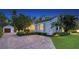 Exterior view of a charming home with a brick driveway and lush landscaping at 1682 Hawthorne St, Sarasota, FL 34239
