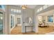 Bright foyer featuring hardwood floors, a round mirror, and views into the dining room at 1682 Hawthorne St, Sarasota, FL 34239