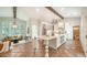 Open concept kitchen featuring white cabinetry, central island with seating and an adjacent cozy living area at 1682 Hawthorne St, Sarasota, FL 34239