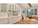 Gourmet kitchen featuring white cabinetry, subway tile backsplash, built-in appliances and adjacent sitting area at 1682 Hawthorne St, Sarasota, FL 34239