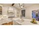 Bright kitchen features a large island with a farmhouse sink, white cabinetry, and modern appliances at 1682 Hawthorne St, Sarasota, FL 34239