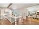 Gourmet kitchen featuring white cabinetry, a central island, and an open view into the dining room at 1682 Hawthorne St, Sarasota, FL 34239