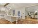Spacious kitchen with large island, white cabinets, stainless steel appliances and view into dining room at 1682 Hawthorne St, Sarasota, FL 34239