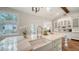 Bright kitchen features a large island with a farmhouse sink, white cabinetry, and modern appliances at 1682 Hawthorne St, Sarasota, FL 34239