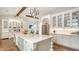 Gourmet kitchen featuring white cabinetry, central island with seating and stainless steel appliances at 1682 Hawthorne St, Sarasota, FL 34239