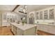 Bright kitchen features a large island with marble countertops, white cabinetry, and modern appliances at 1682 Hawthorne St, Sarasota, FL 34239