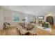 Spacious living room with hardwood floors, fireplace, an adjacent dining area, and ample natural light at 1682 Hawthorne St, Sarasota, FL 34239