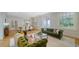 Spacious living area with hardwood floors, a fireplace, comfortable seating, and an open dining space at 1682 Hawthorne St, Sarasota, FL 34239