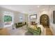 Inviting living area with plush green sofas, fireplace, and a seamless flow to an outdoor patio at 1682 Hawthorne St, Sarasota, FL 34239