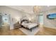 A main bedroom features a king bed, hardwood floors, and a chandelier at 1682 Hawthorne St, Sarasota, FL 34239
