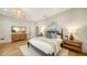 A main bedroom features a king bed, hardwood floors, and a chandelier at 1682 Hawthorne St, Sarasota, FL 34239