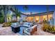 Beautiful outdoor patio with a cozy fire pit, comfortable seating, and dining area for enjoying evenings outdoors at 1682 Hawthorne St, Sarasota, FL 34239