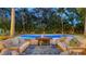 Relaxing outdoor patio with a fire pit, comfortable seating, and mature landscaping for evening enjoyment at 1682 Hawthorne St, Sarasota, FL 34239