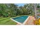 Beautiful backyard featuring a refreshing pool, lush landscaping, and a serene atmosphere perfect for relaxation and outdoor enjoyment at 1682 Hawthorne St, Sarasota, FL 34239