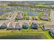 Aerial view of houses and a lake in a residential area at 17113 Reserva Dr, Bradenton, FL 34211