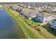 Aerial view of a house with fenced backyard and lake access at 17113 Reserva Dr, Bradenton, FL 34211