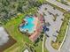 Aerial view of community pool, parking lot, and surrounding landscape at 17113 Reserva Dr, Bradenton, FL 34211