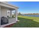 Covered patio overlooking a lake with seating area at 17113 Reserva Dr, Bradenton, FL 34211