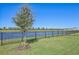 Private backyard with pond view and black metal fence at 17113 Reserva Dr, Bradenton, FL 34211