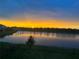 Stunning sunset view over a peaceful backyard pond at 17113 Reserva Dr, Bradenton, FL 34211
