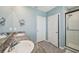 Bathroom with double sinks, walk-in shower, and tiled floors at 17113 Reserva Dr, Bradenton, FL 34211