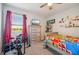 This colorful bedroom offers a ceiling fan and a window with natural light at 17113 Reserva Dr, Bradenton, FL 34211