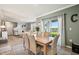 Dining area with lots of natural light, a wooden table, and a view of the lake at 17113 Reserva Dr, Bradenton, FL 34211