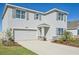 Two-story house with gray siding, stone accents, and a two-car garage at 17113 Reserva Dr, Bradenton, FL 34211
