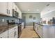 Well-equipped kitchen with granite countertops, stainless steel appliances, and white cabinets at 17113 Reserva Dr, Bradenton, FL 34211