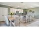 Bright kitchen with granite countertops, a modern island with seating, and stainless steel appliances at 17113 Reserva Dr, Bradenton, FL 34211