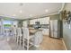 Well-lit kitchen and eating area feature stainless steel appliances, a center island, and granite countertops at 17113 Reserva Dr, Bradenton, FL 34211