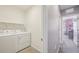 This laundry room has a washer, dryer and shelving at 17113 Reserva Dr, Bradenton, FL 34211