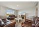 Living room with brown leather furniture and electric fireplace at 17113 Reserva Dr, Bradenton, FL 34211