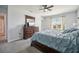 Relaxing main bedroom with plush carpeting, a large bed, and a view of the outside at 17113 Reserva Dr, Bradenton, FL 34211