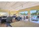 Outdoor kitchen and seating area with granite countertop and wicker chairs, adjacent to the pool at 17113 Reserva Dr, Bradenton, FL 34211