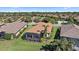 Aerial view showing house with a screened patio, landscaping, and neighboring homes at 2467 Vaccaro Dr, Sarasota, FL 34231