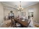 Spacious dining area with large table, chandelier, and hardwood floors at 2467 Vaccaro Dr, Sarasota, FL 34231