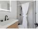 Modern bathroom with a sleek white vanity, frameless shower, and hexagon tile floor at 303 65Th St # A, Holmes Beach, FL 34217