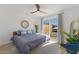 Bright bedroom with a king-size bed, large windows, and sliding glass doors leading to a deck at 303 65Th St # A, Holmes Beach, FL 34217