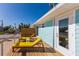 Private deck with yellow lounge chairs and a view at 303 65Th St # A, Holmes Beach, FL 34217