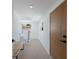 Bright and airy entryway with modern wood bench, staircase with cable railing, and wood door at 303 65Th St # A, Holmes Beach, FL 34217