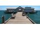 Wooden pier extending over the water to a fishing pier building at 303 65Th St # A, Holmes Beach, FL 34217