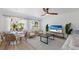 Open concept living area with comfortable seating, dining table, and large TV at 303 65Th St # A, Holmes Beach, FL 34217